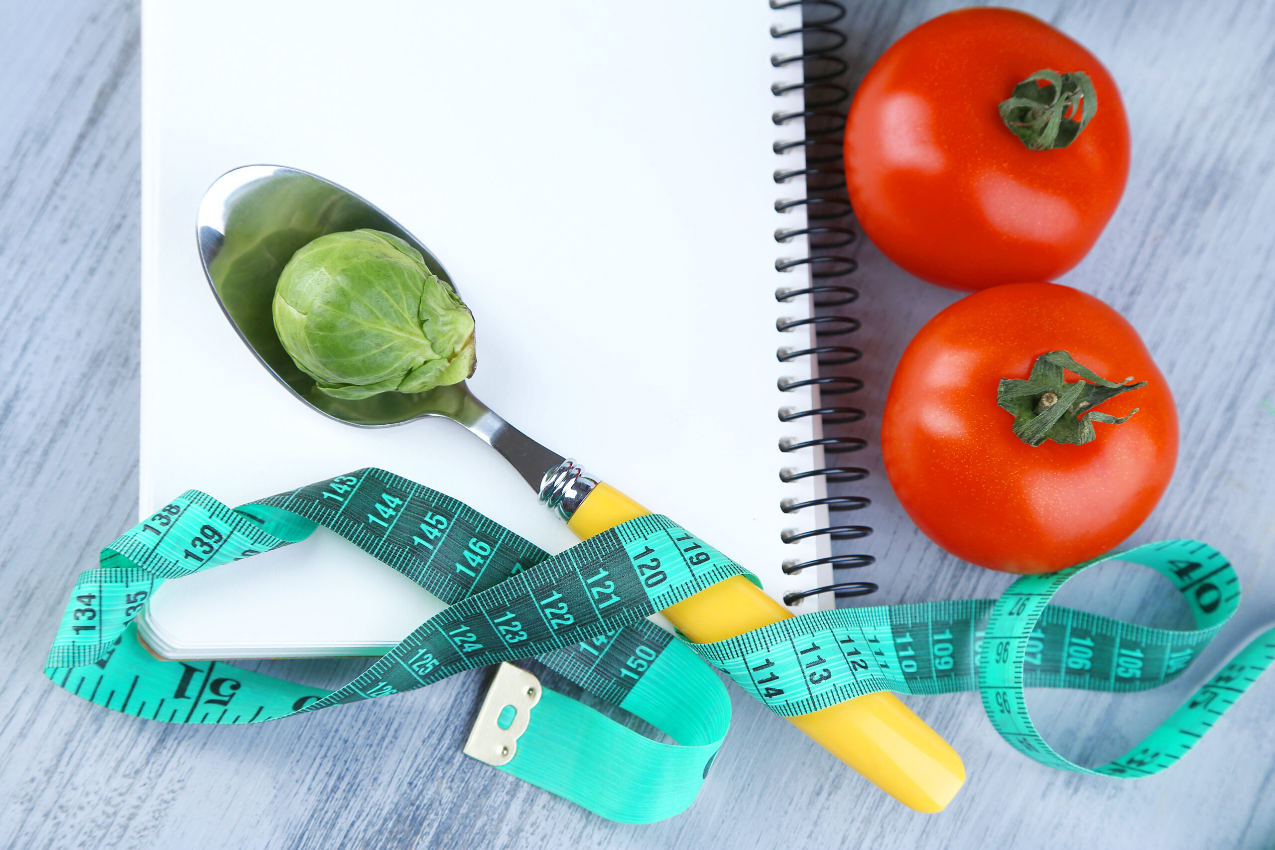 Notebook,With,Measuring,Tape,And,Vegetables,On,Wooden,Background