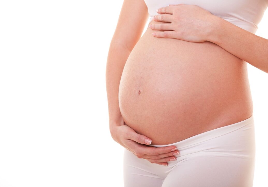 Image of pregnant woman touching her big belly. Close up. Motherhood, pregnancy, people and expectation concept. Pregnant woman expecting baby