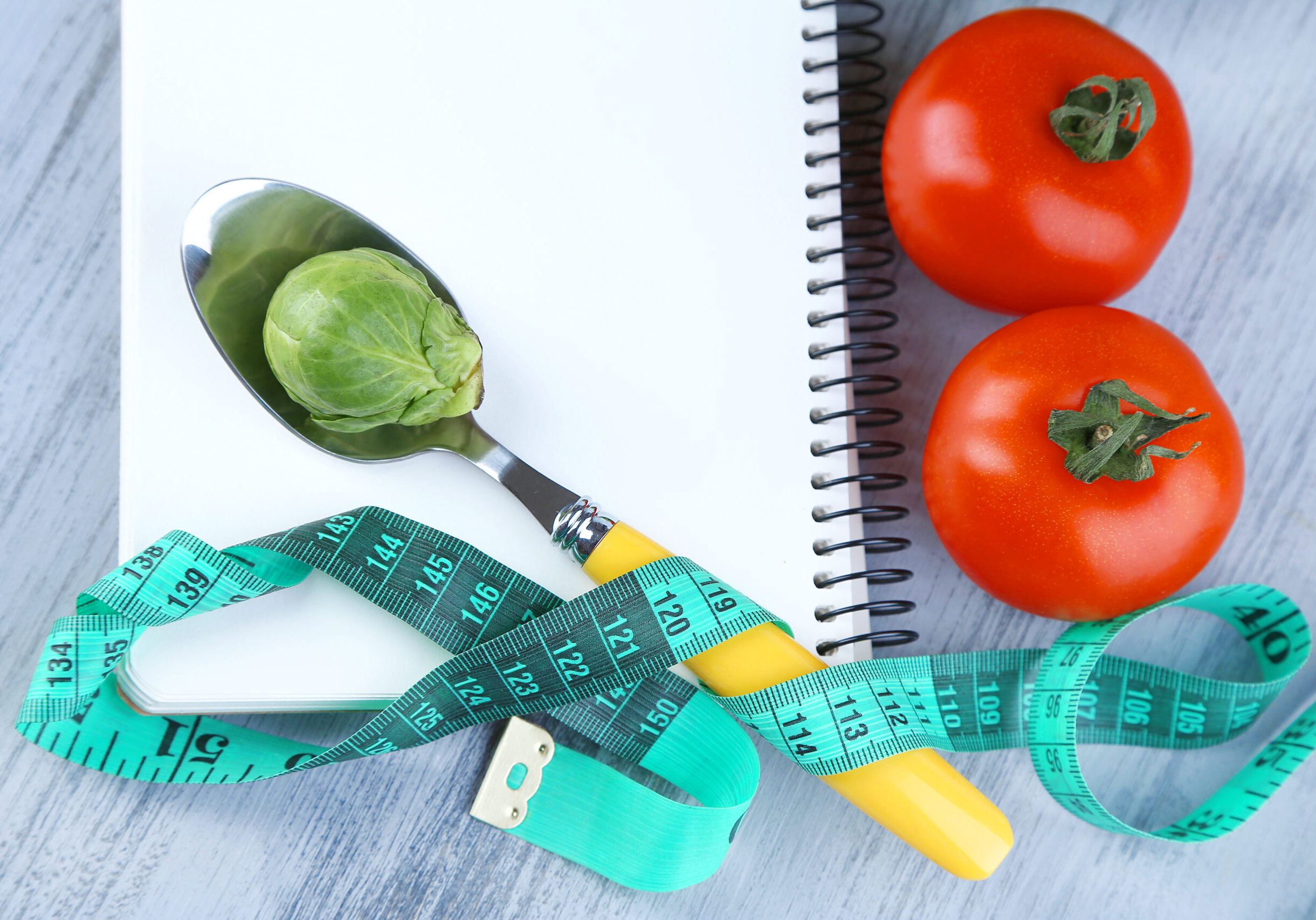 Notebook,With,Measuring,Tape,And,Vegetables,On,Wooden,Background