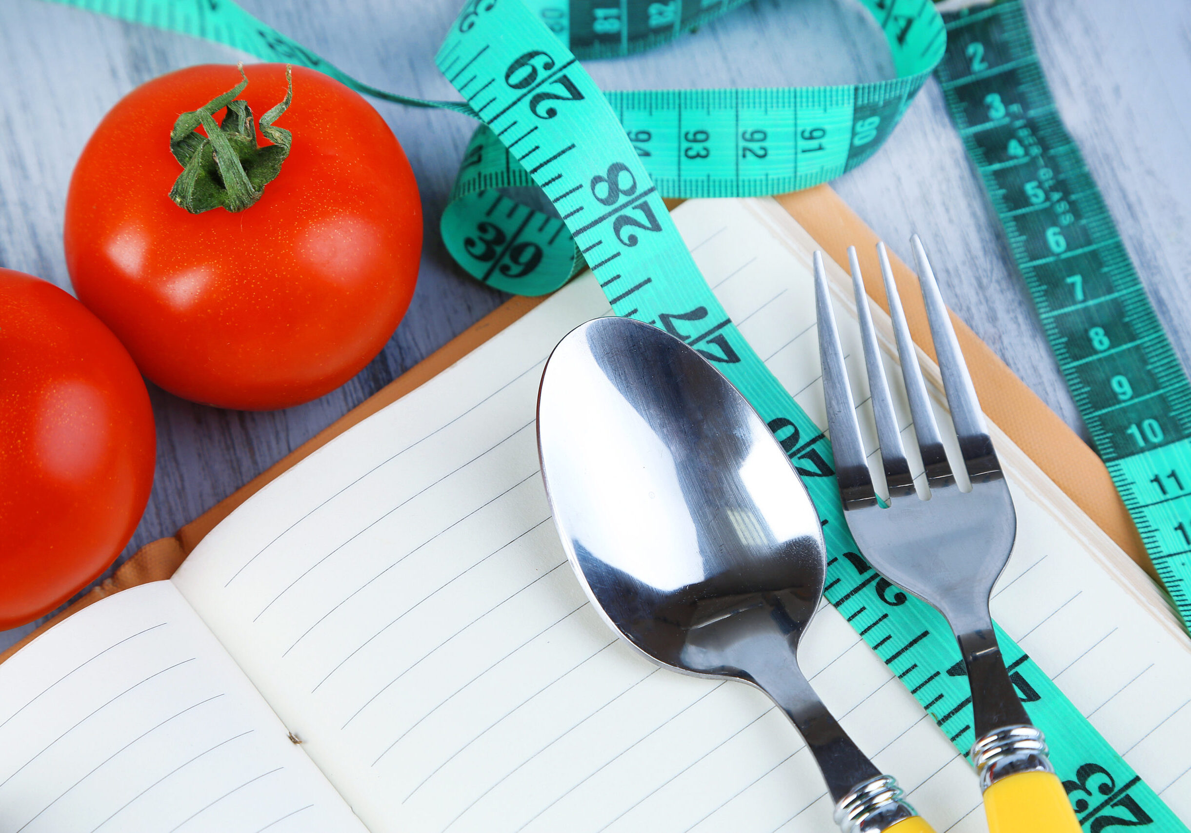 Cutlery,Tied,With,Measuring,Tape,And,Book,With,Vegetables,On